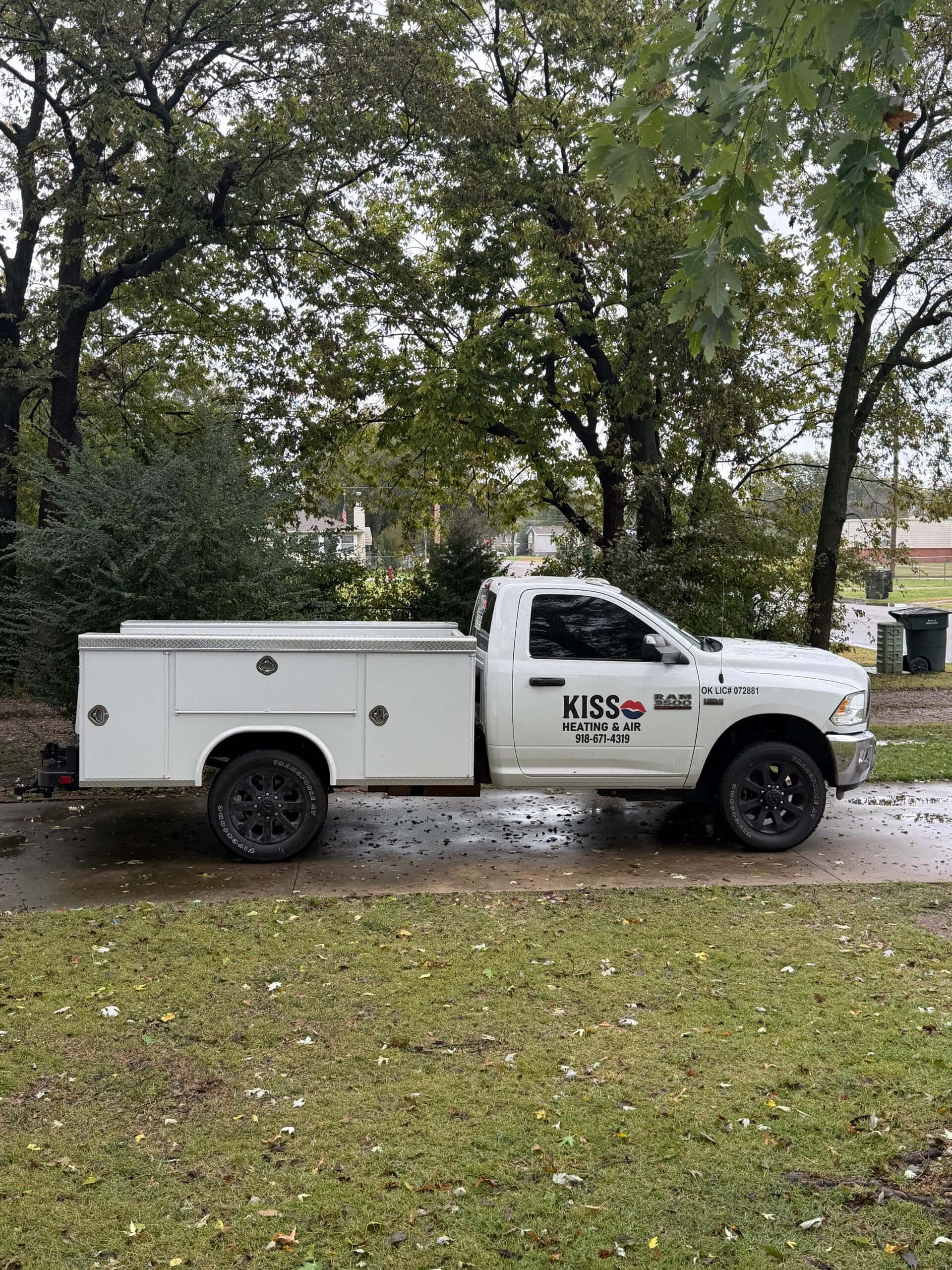KISS Heating and Air work truck parked at a Tulsa home