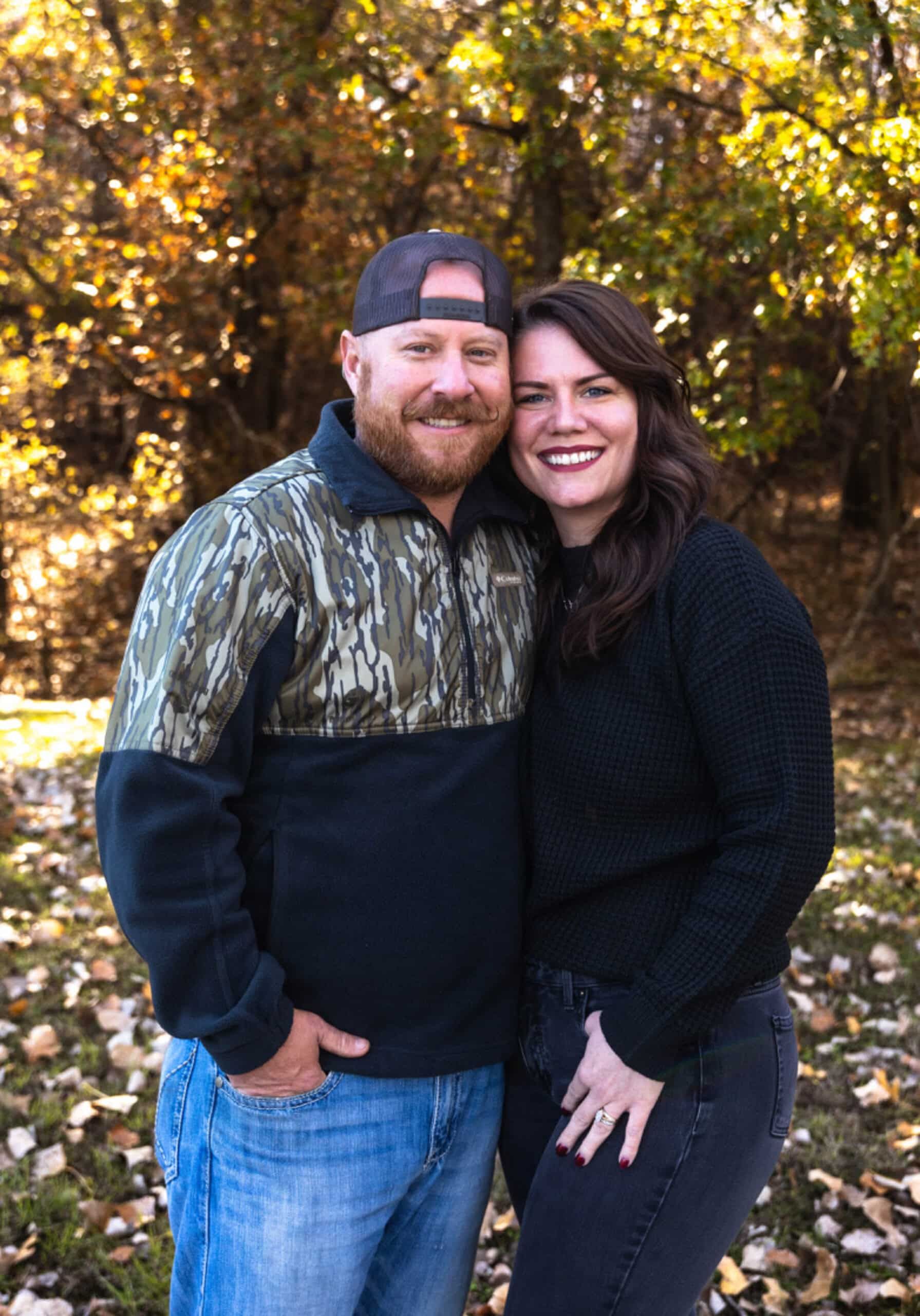 Brandon McBee with family under a fall tree